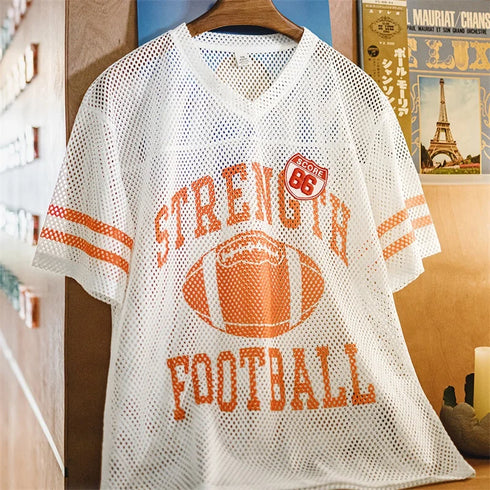 White mesh sports jersey with orange text and football graphic on a hanger.